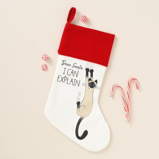 Funny Siamese Cat Hanging On Christmas Stocking